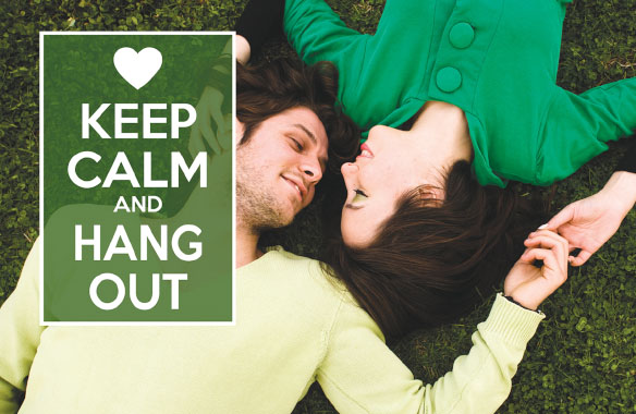 Keep Calm and Hang Out' with heart on green background over photo of couple lying on grass.