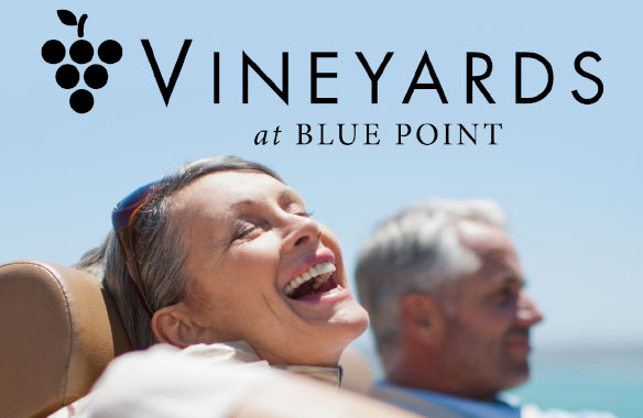 The Vineyards at Blue Point black logo with grape graphic on photo of older laughing couple in convertible car.